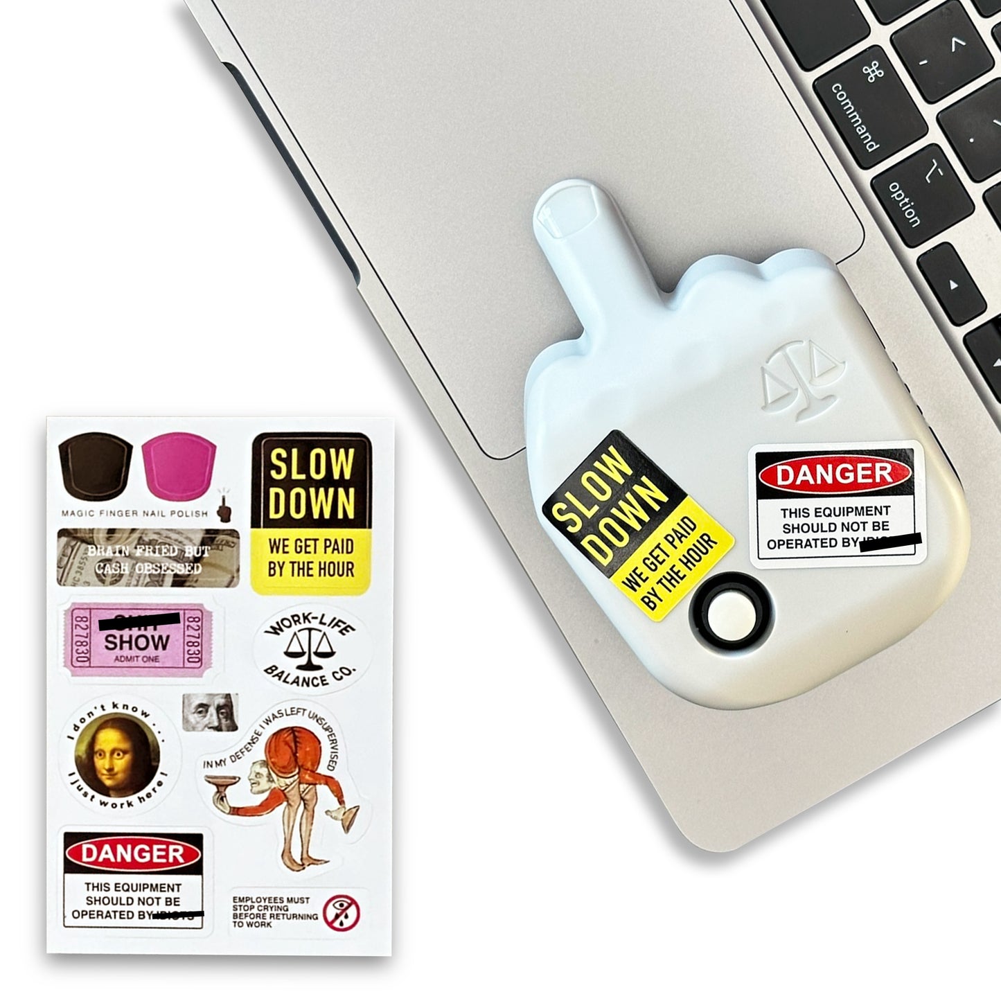 White hand-shaped device with stickers on a laptop
